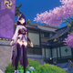 The Raiden Shogun stands next to a palace and some cherry blossom trees.